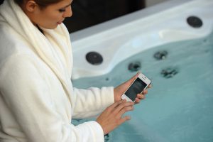 Woman connecting her phone's WiFi to Vita Spa controls